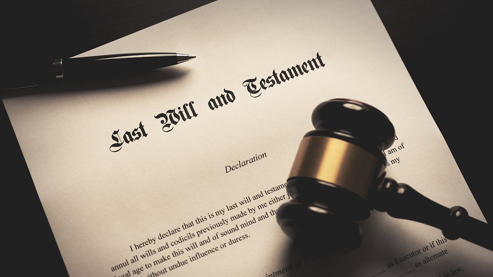 A last will and testament document with a pen