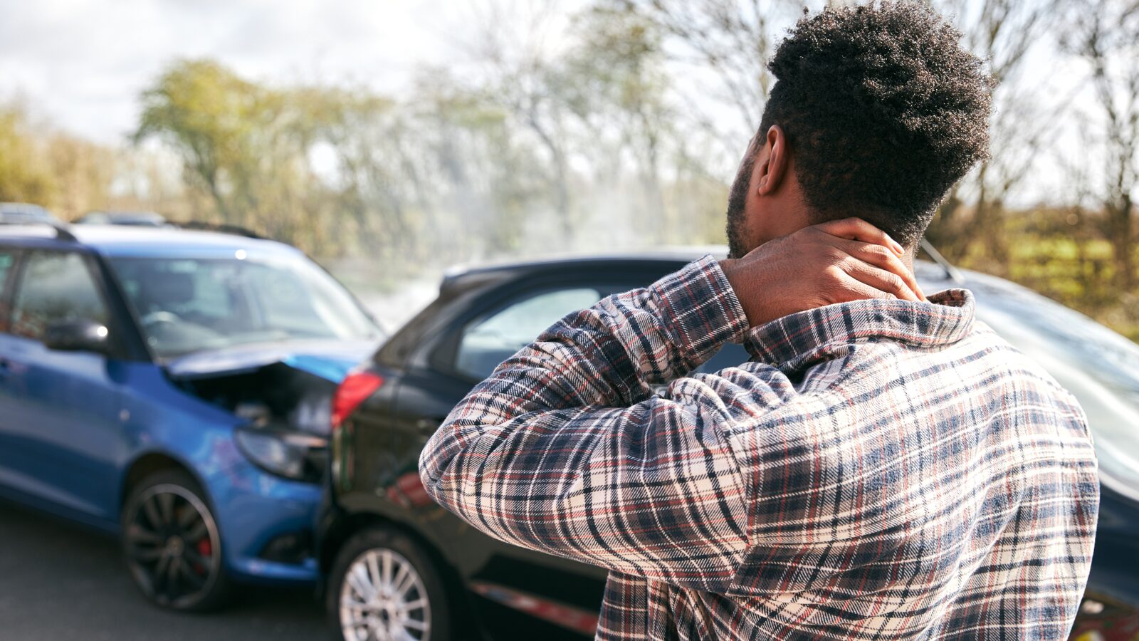 A driver at the roadside after a collision